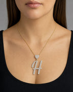 Female model wearing 14K Initial H Script Heart Diamond Pendant