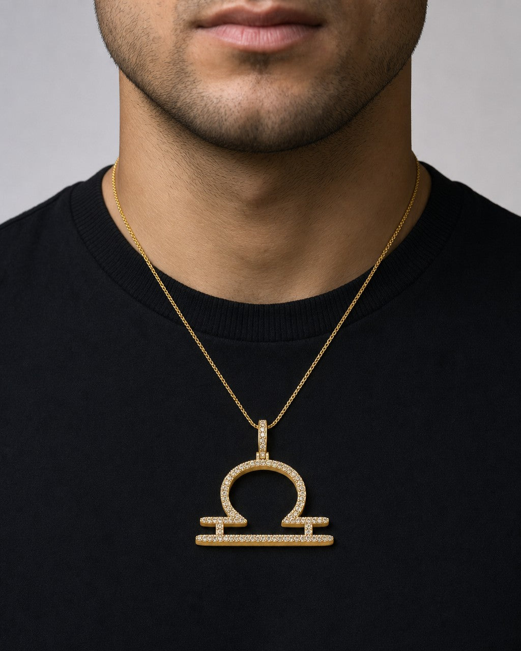 Male model wearing 10K Libra Sign Diamond Pendant