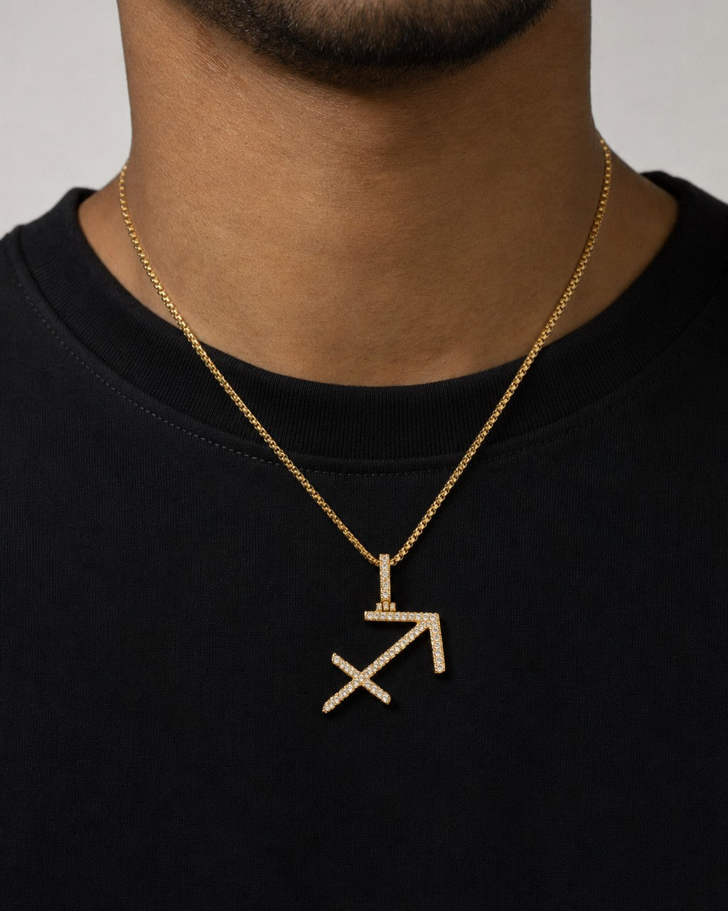 Male model wearing 10K Sagittarius Sign Diamond Pendant
