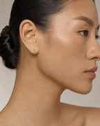 Female model wearing 10K Luxury Crown Diamond Earrings