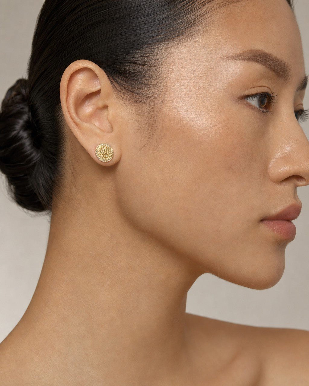 Female model wearing 10K Luxury Crown Diamond Earrings