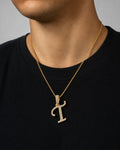 Male model wearing 10K Cursive T Initial Diamond Pendant