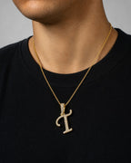 Male model wearing 10K Cursive T Initial Diamond Pendant