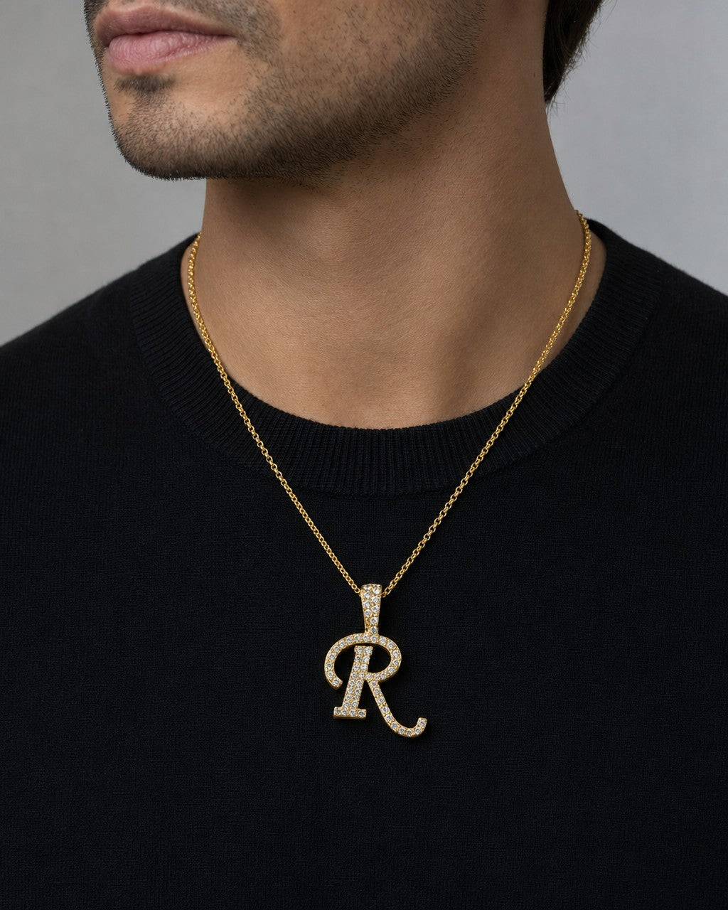 Male model wearing 10K Cursive R Initial Diamond Pendant