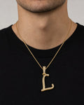Male model wearing 10K Cursive L Initial Diamond Pendant