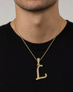 Male model wearing 10K Cursive L Initial Diamond Pendant