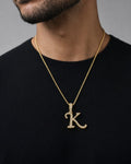Male model wearing 10K Cursive K Initial Diamond Pendant