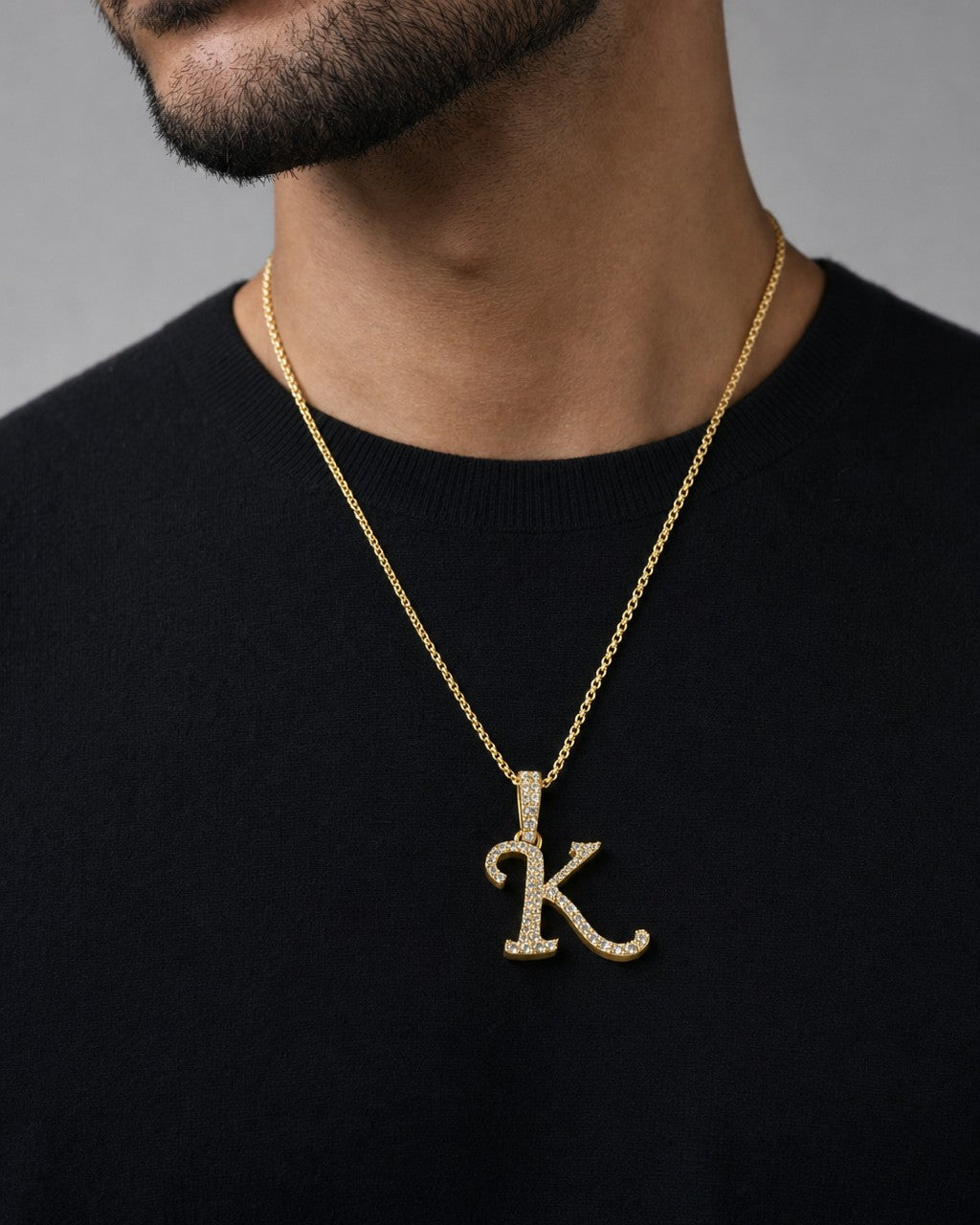 Male model wearing 10K Cursive K Initial Diamond Pendant