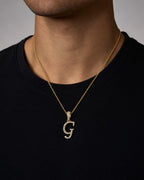 Male model wearing 10K Cursive G Initial Diamond Pendant