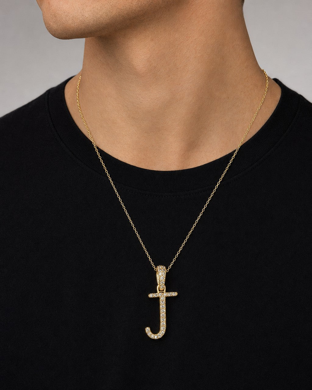 Male model wearing 10K Cursive J Initial Diamond Pendant