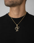 Male model wearing 10K Cursive F Initial Diamond Pendant