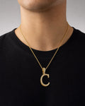 Male model wearing 10K Cursive C Initial Diamond Pendant