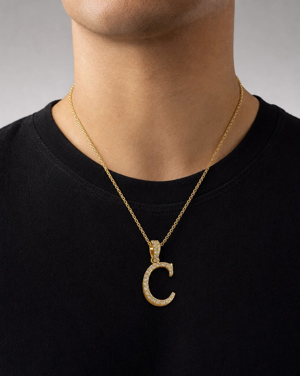 Male model wearing 10K Cursive C Initial Diamond Pendant