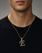 Male model wearing 10K Cursive E Initial Diamond Pendant