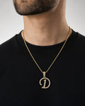 Male model wearing 10K Cursive D Initial Diamond Pendant