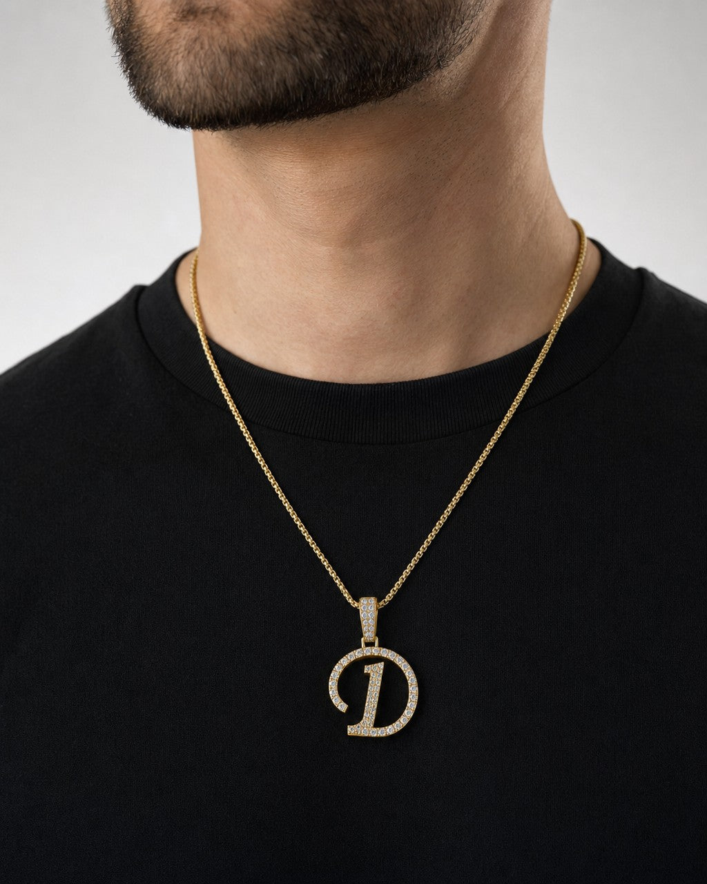 Male model wearing 10K Cursive D Initial Diamond Pendant