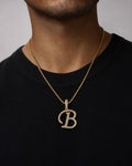 Male model wearing 10K Cursive B Initial Diamond Pendant