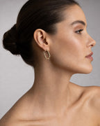 Female model wearing 10K Braided Rectangle Hoop Earrings