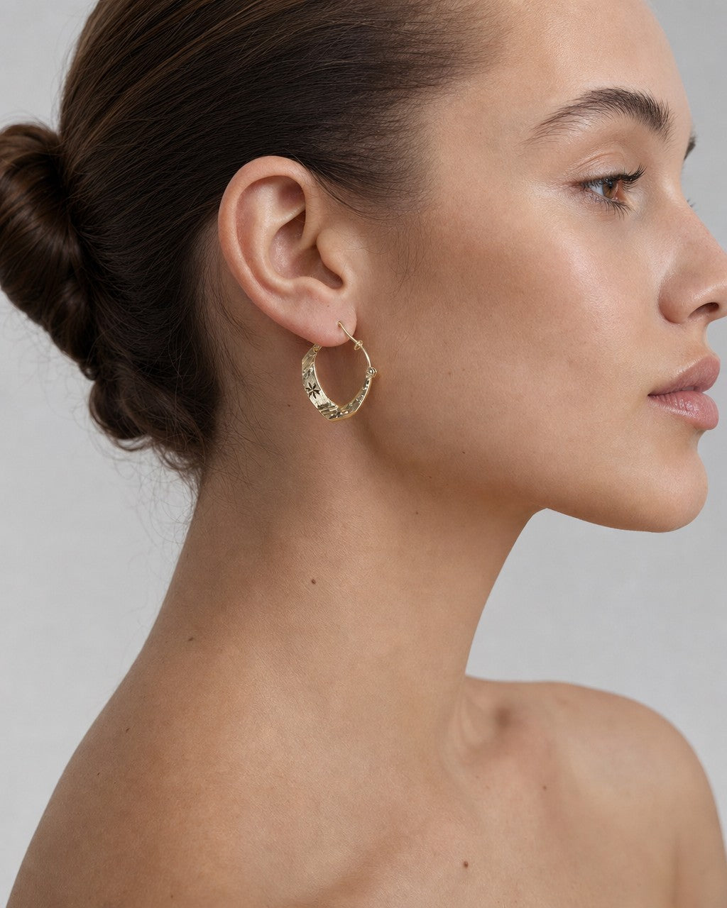 Female model wearing 10K Winter Flower Crown Hoop Earrings