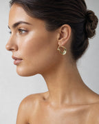 Female model wearing 10K Crescent Moon Hoop Earrings