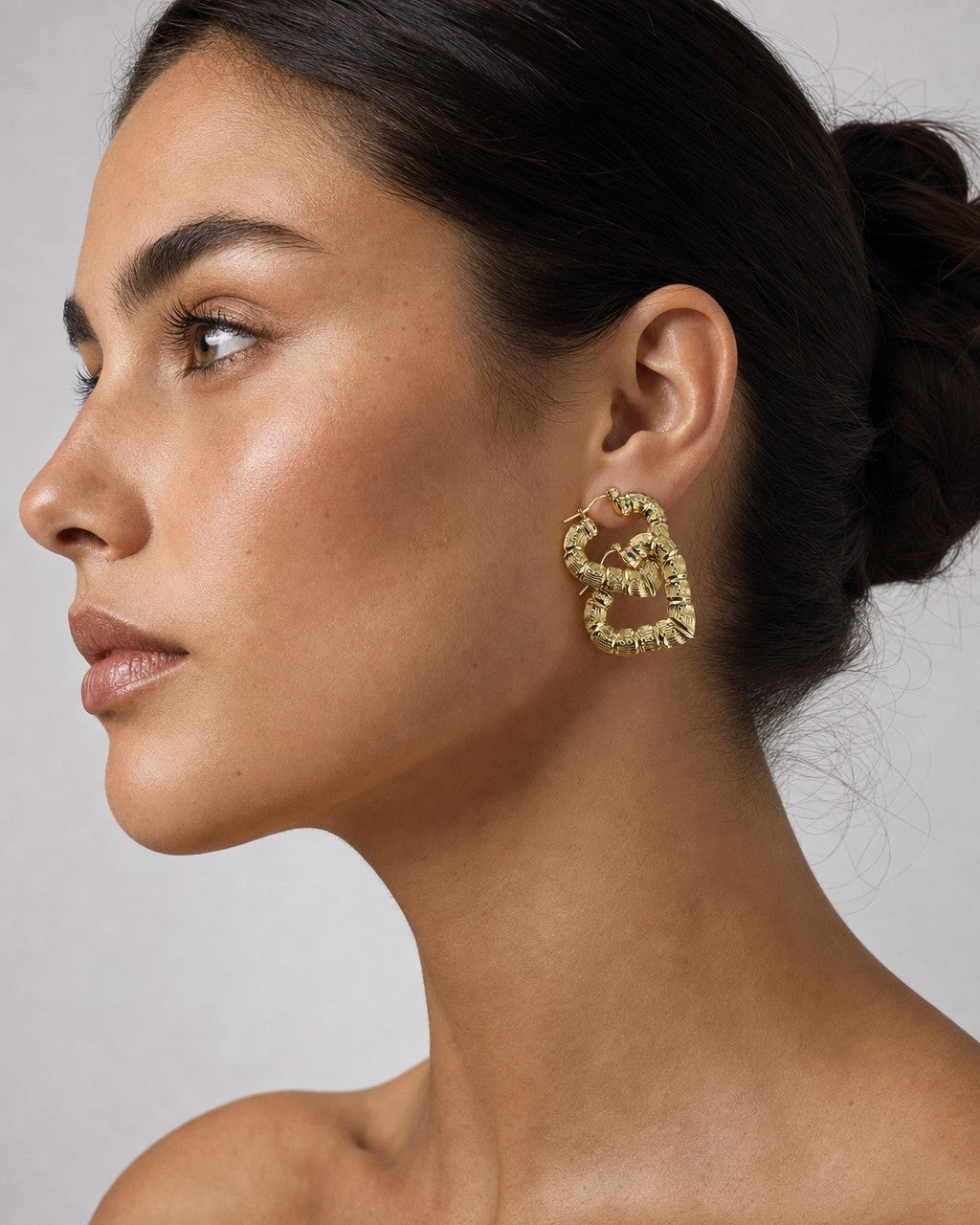 Female model wearing 10K Perfect Bamboo Heart Hoop Earrings