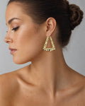 Female model wearing 10K Puff Heart Hoop Earrings