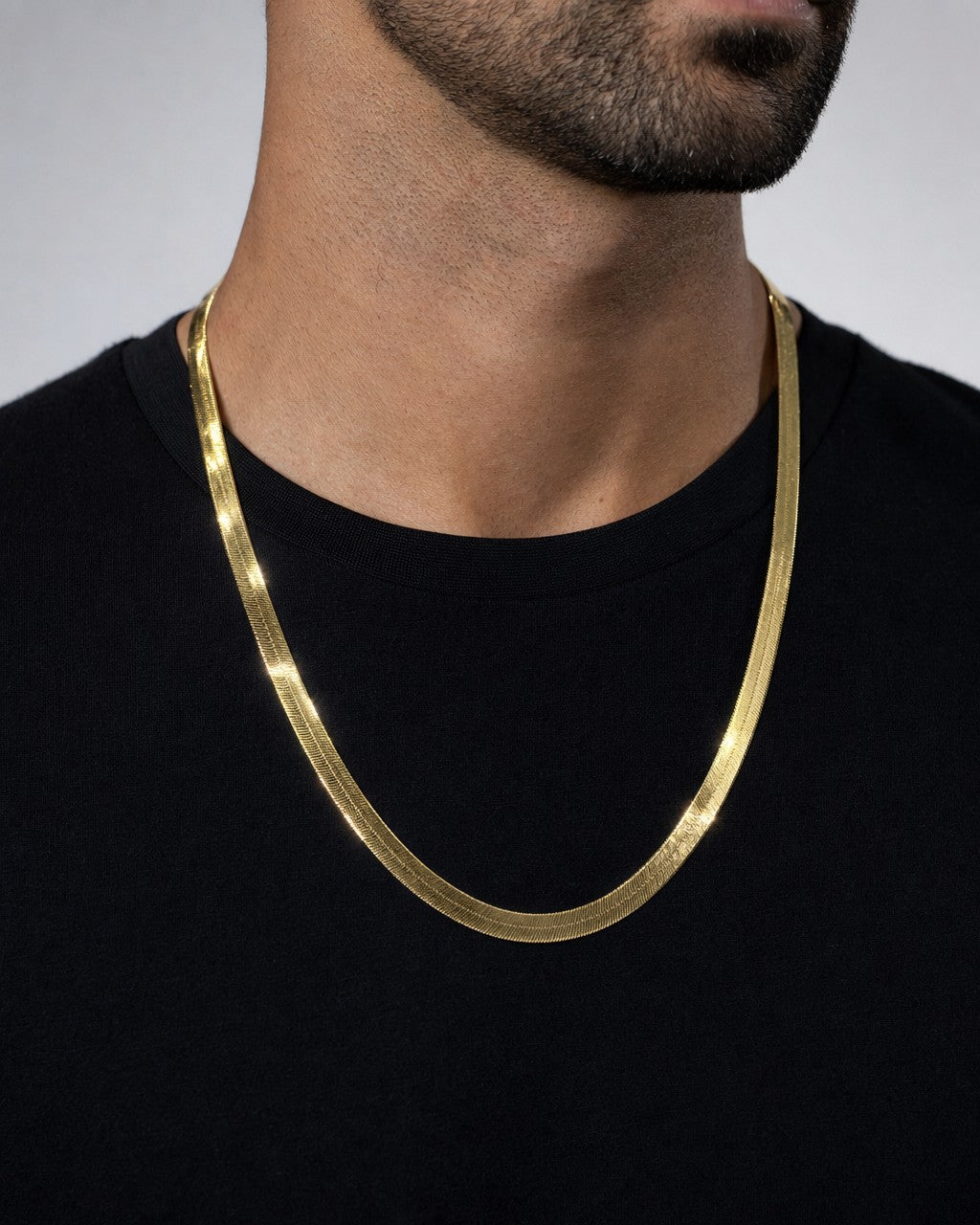 Male model wearing 10K 9MM Herringbone Link Necklace 24"