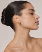 Female model wearing 14K Solid Gold Slim Hoop Earrings
