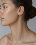Female model wearing 14K Triangle Diamond Baguette Earrings