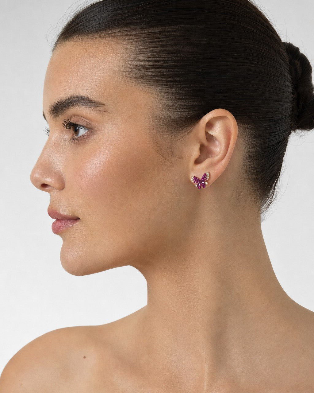 Female model wearing 14K Large Purple Butterfly Diamond Earrings