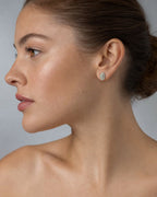 Female model wearing 14K Small Oval Stacked Diamond Baguette Earrings