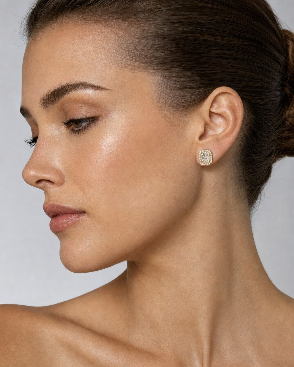 Female model wearing 14K Small Rectangle Rounded Halo Diamond Baguette Earrings