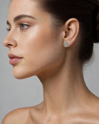 Female model wearing 14K Large Rectangle Rounded Halo Diamond Baguette Earrings