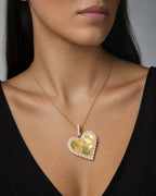 Female model wearing 10K Yellow Gold Diamond Heart Plate Pendant