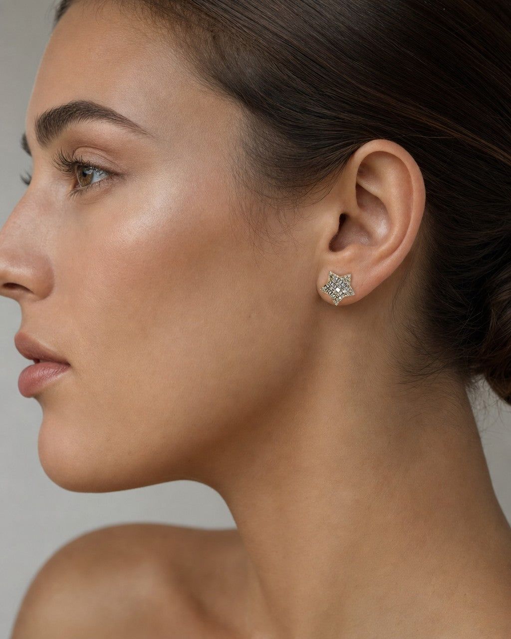 Female model wearing 14K Large Star Stacked Diamond Baguette Earrings