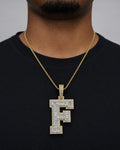 Male model wearing 10K Initial F Diamond Baguette Pendant