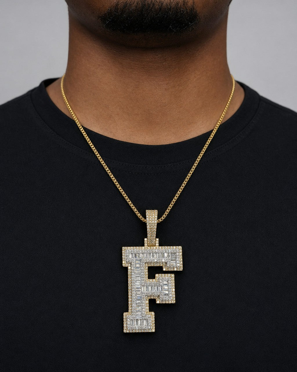 Male model wearing 10K Initial F Diamond Baguette Pendant
