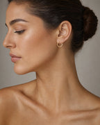 Female model wearing 14K Gold Hoop Earrings