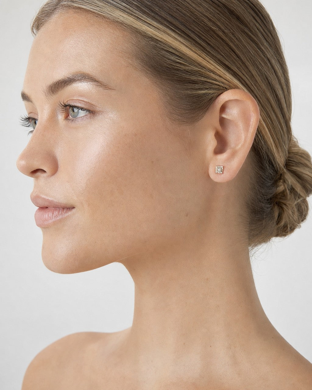 Female model wearing 10K Classic Square Gold and Diamond Earrings