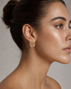 Female model wearing 14K Gold Flower Earrings