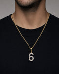 Male model wearing 14K Number 6 Diamond Pendant