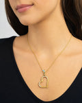 Female model wearing 14K Heart Yellow Outline Diamond Pendant