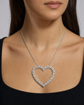 Female model wearing 14k Heart Outline Diamond Pendant