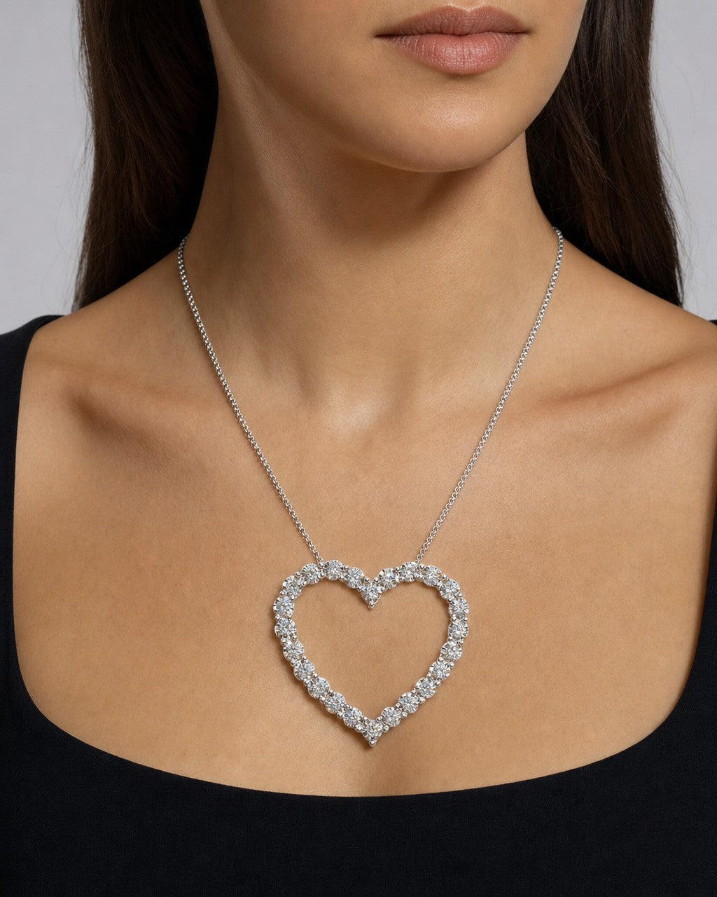 Female model wearing 14k Heart Outline Diamond Pendant