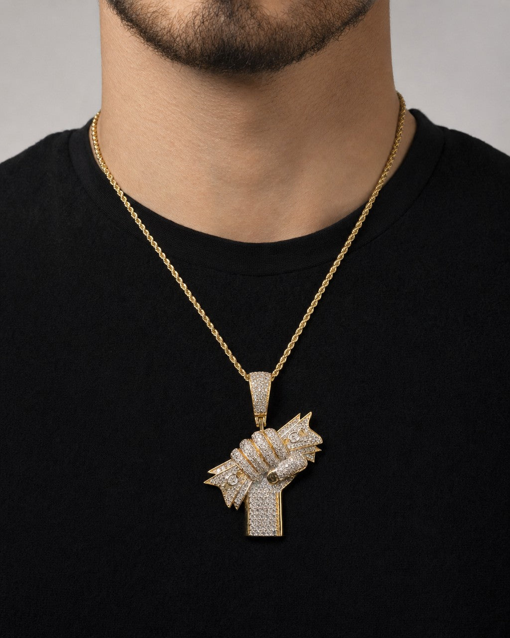 Male model wearing 14K Money Hand Diamond Pendant