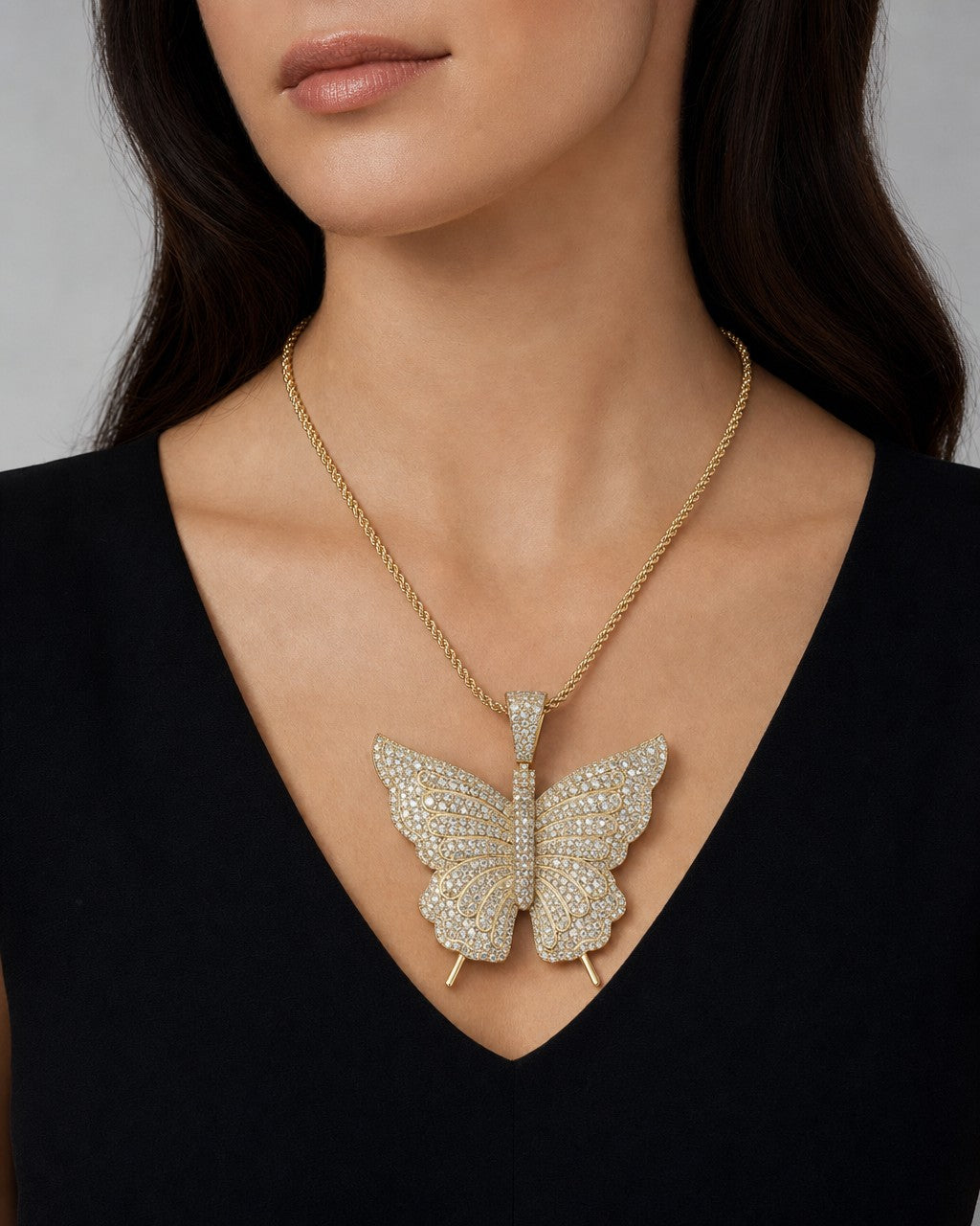 Female model wearing 14k Butterfly Diamond Pendant