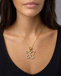 Female model wearing 10K Butterfly Outline Pendant