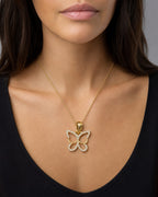 Female model wearing 10K Butterfly Outline Pendant