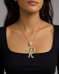 Female model wearing 14k Initial R Script Heart Pendant
