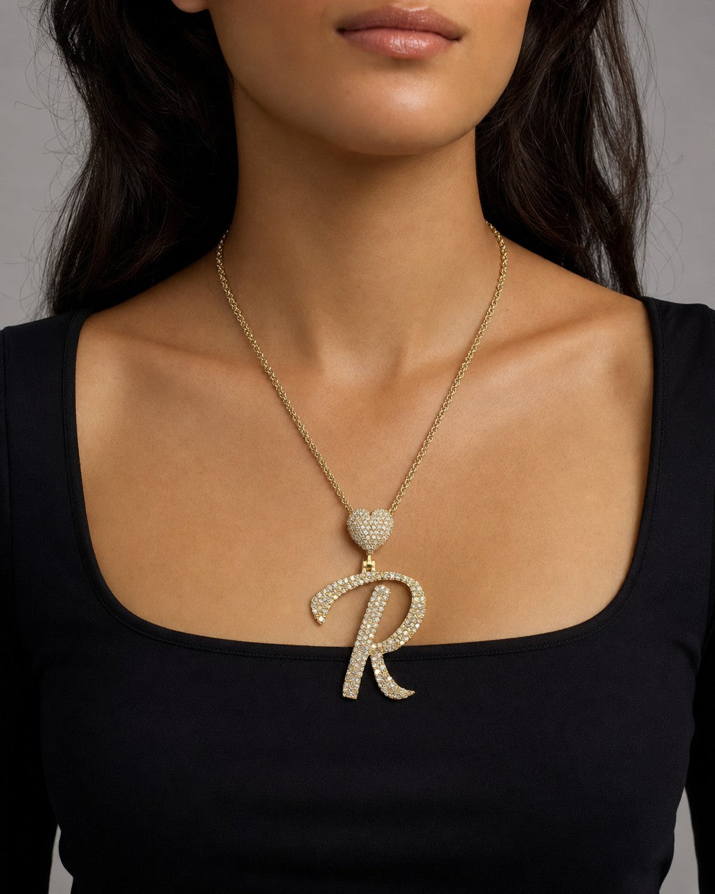 Female model wearing 14k Initial R Script Heart Pendant